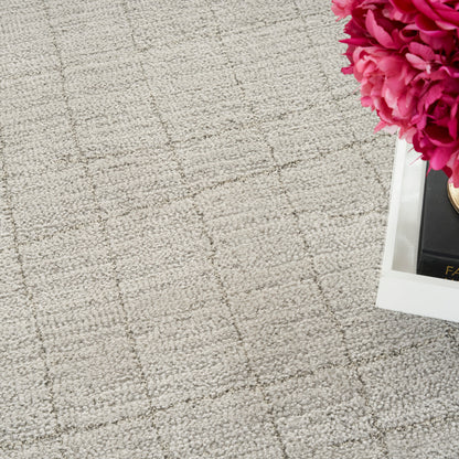 Beige textured rug with a subtle square grid pattern.