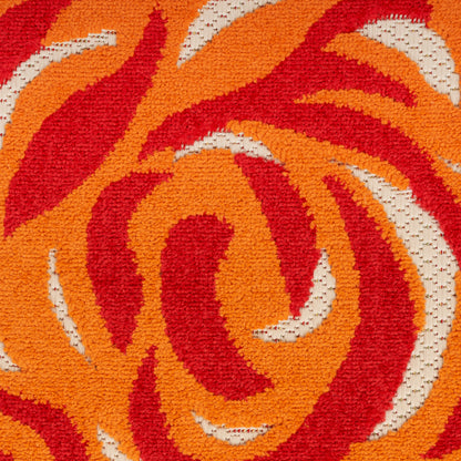 Textured orange and red spiral-pattern rug with cream accents; bold retro tufted design.