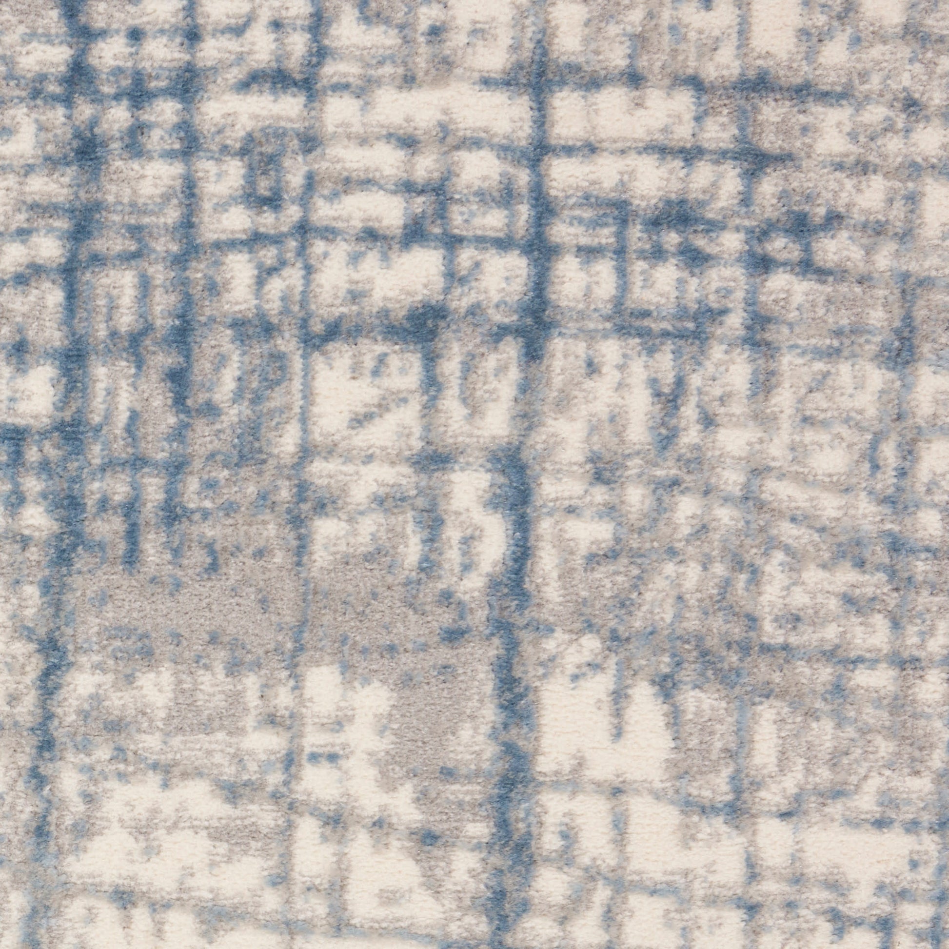 Beige rug with blue abstract grid pattern, distressed geometric motif, plush pile for living room decor.