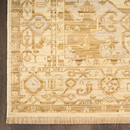Beige oriental rug with geometric and floral motifs, light tan and cream tones, fringed edges.