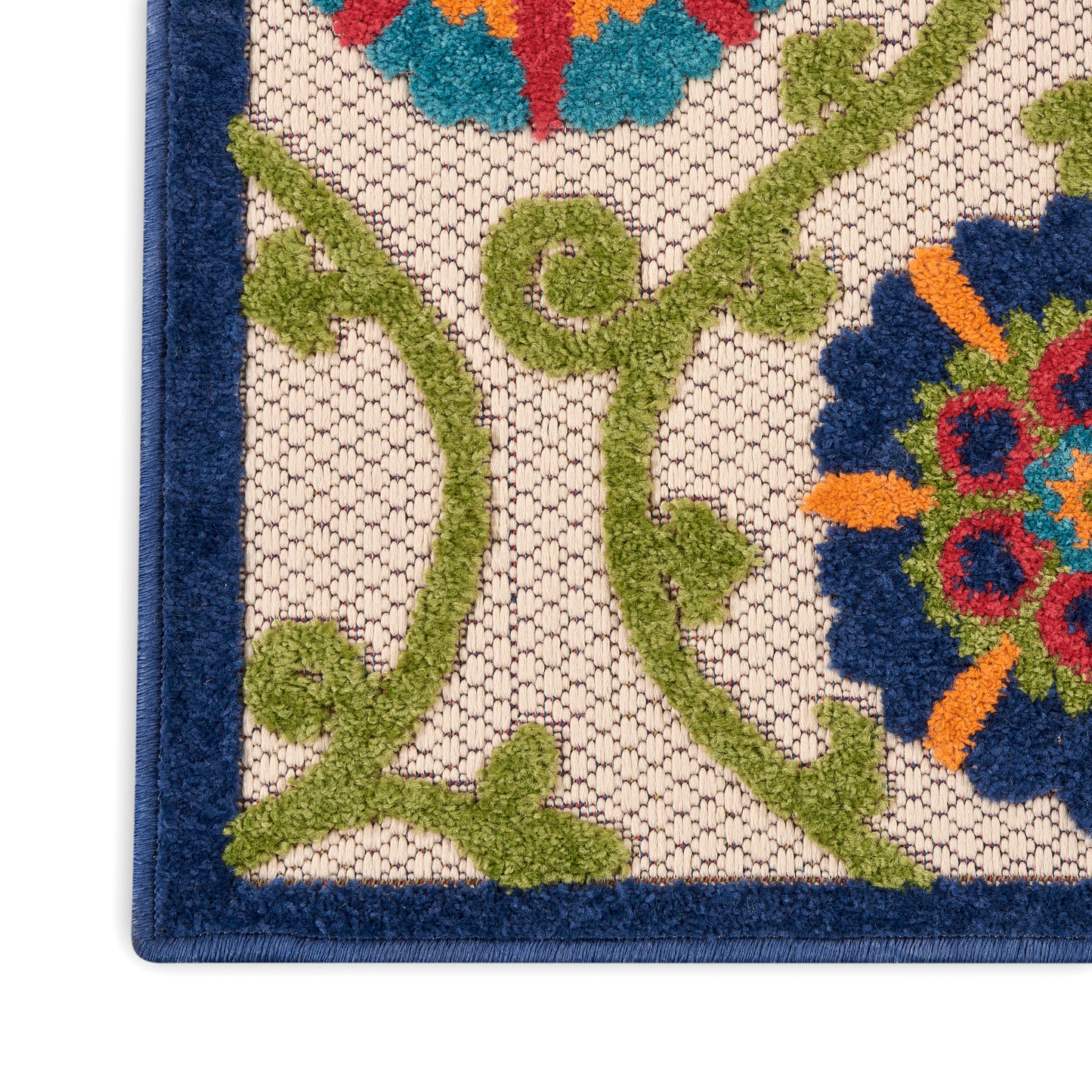 Close-up of ornate floral rug corner on a contemporary 10' runner: beige background, green vines, cobalt-blue border, and colorful flower motifs.