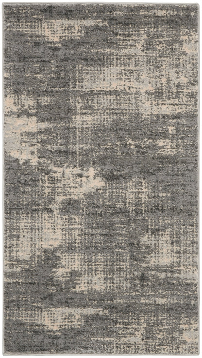 Rectangular area rug in charcoal gray and beige with abstract distressed pattern, plush pile.