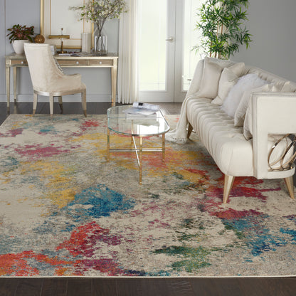 Cream tufted sofa with white cushions, glass coffee table, colorful abstract rug, gold legs, bright living room
