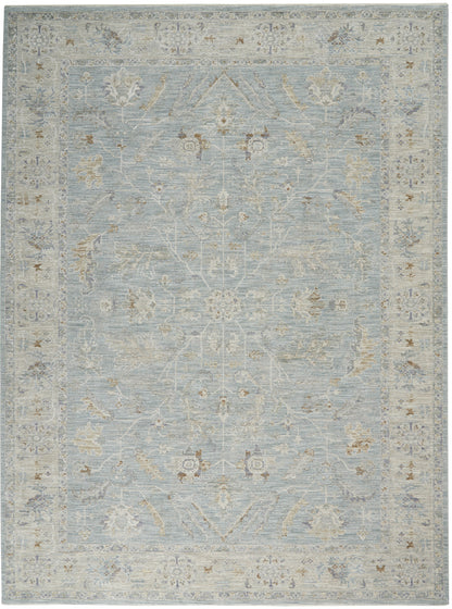 Rectangular light-blue Persian-style rug with ivory border and pale floral vines for traditional living spaces.