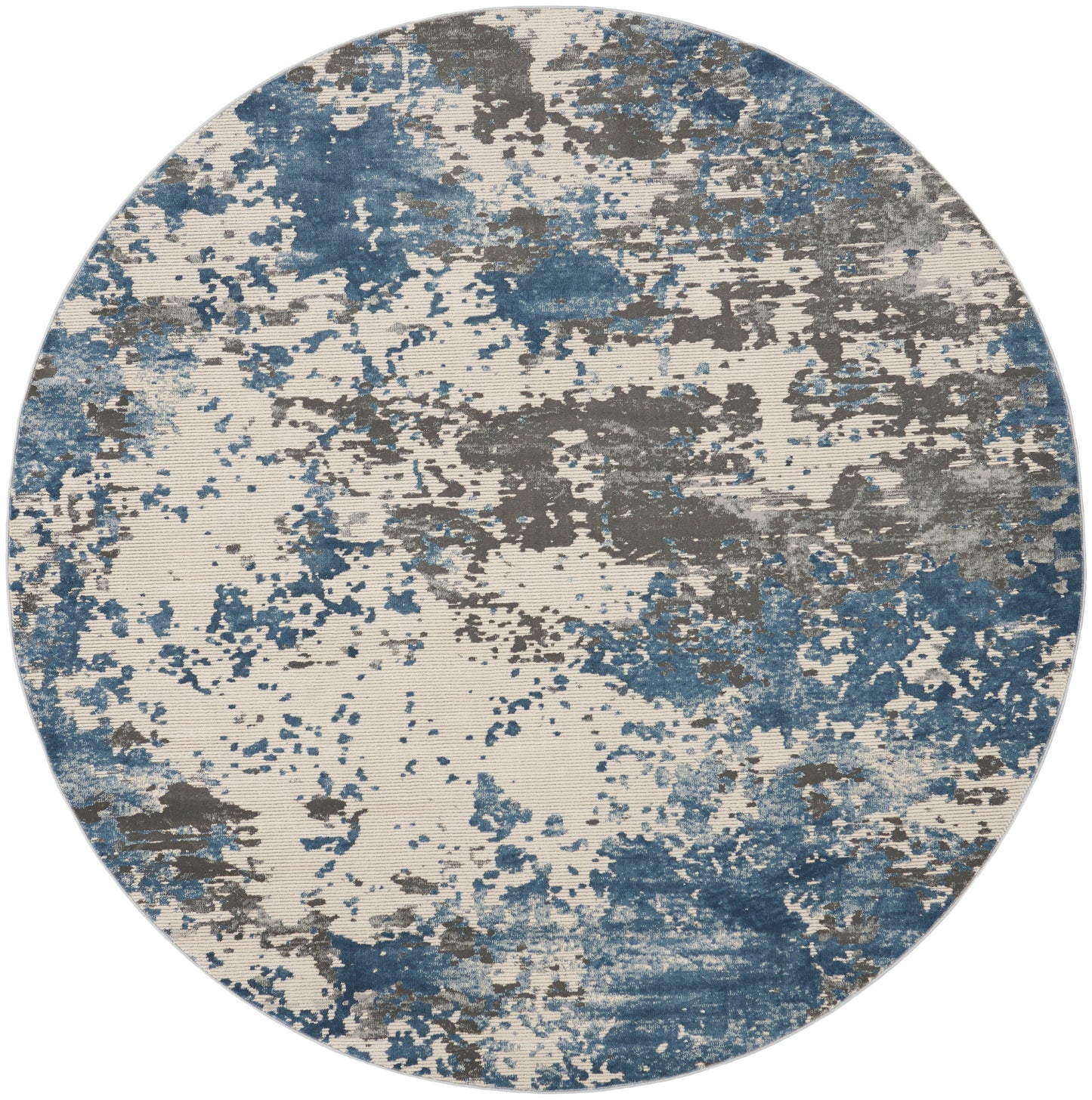 Round rug with abstract blue, gray and beige splatter pattern.