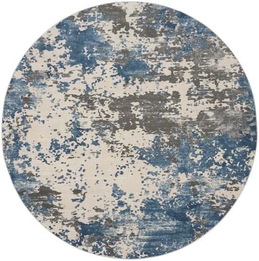 Round rug with abstract blue, gray and beige splatter pattern.