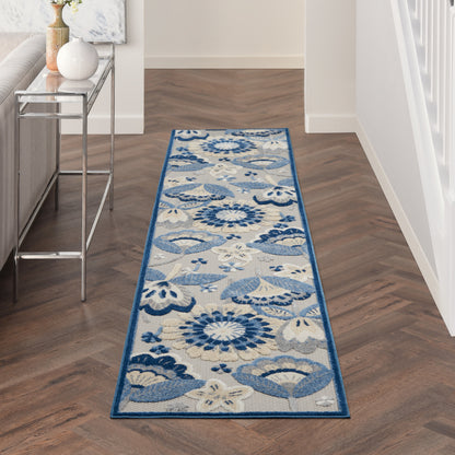 Blue floral patterned hallway runner rug with a light beige background and a dark blue border on a wood floor.