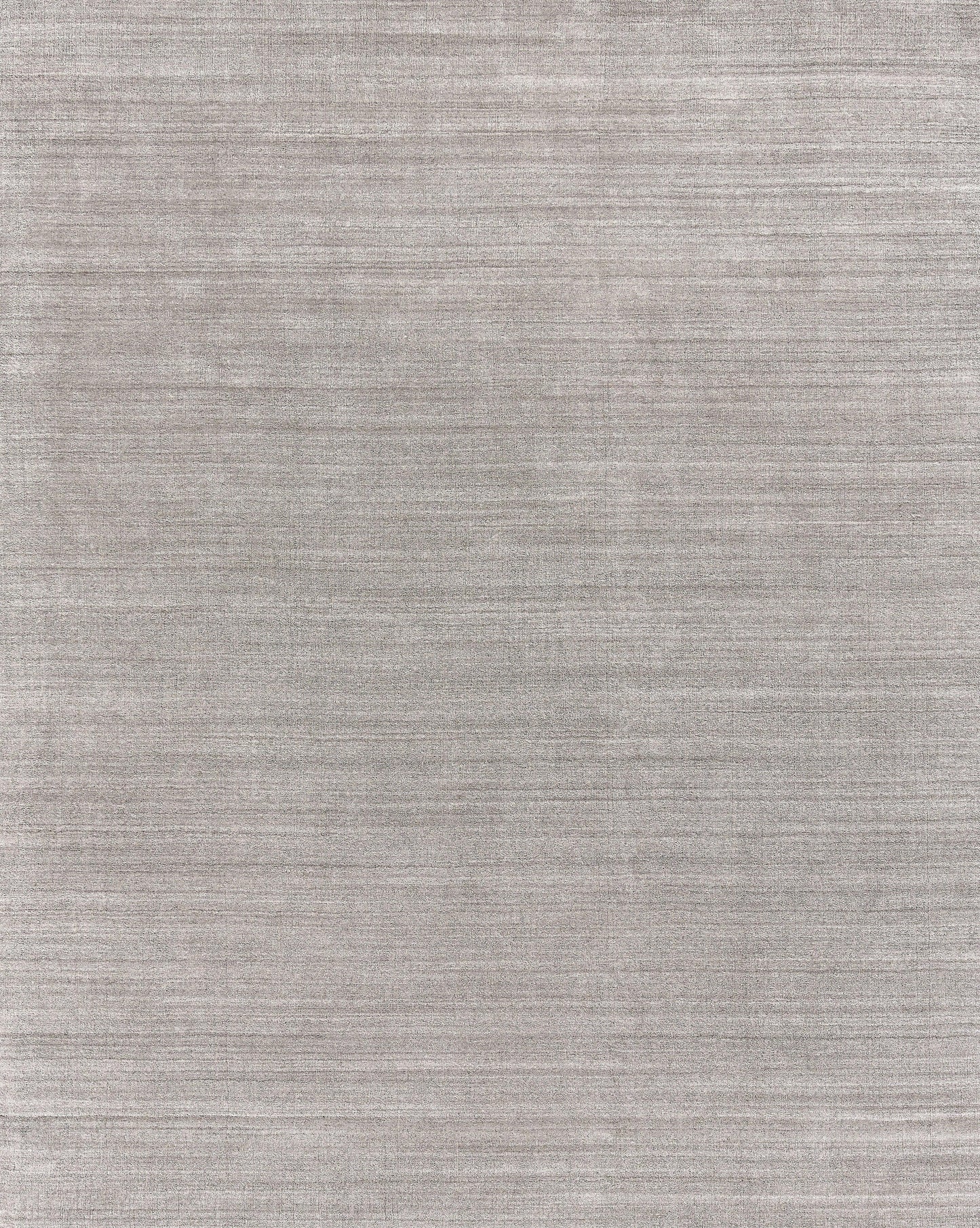 Gray textured rug with subtle horizontal weave and soft, heathered finish; hand loomed.