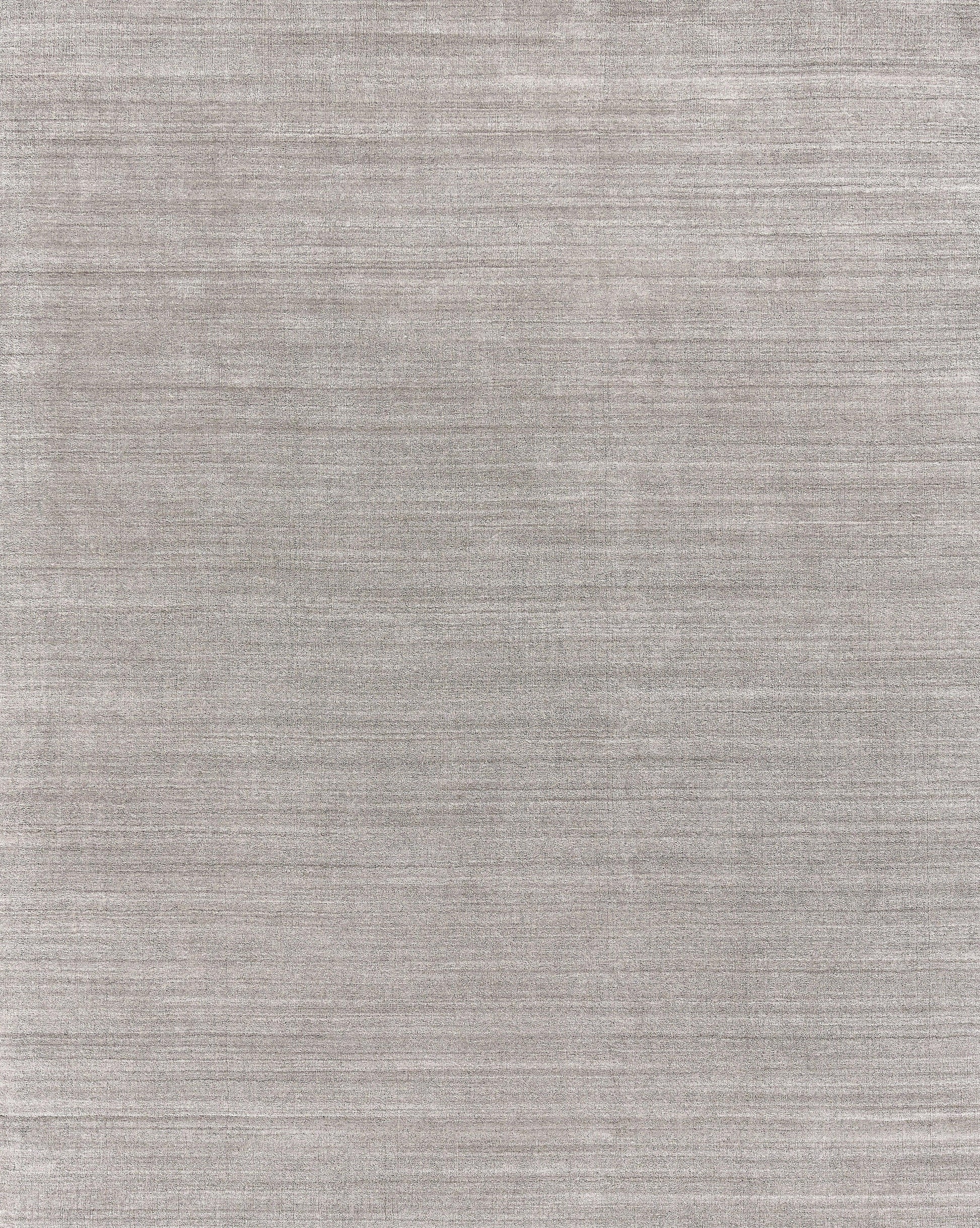 Gray textured rug with subtle horizontal weave and soft, heathered finish; hand loomed.