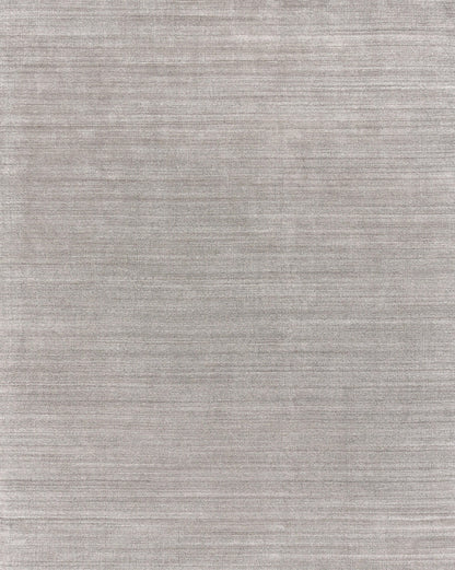 Gray textured rug with subtle horizontal weave and soft, heathered finish; hand loomed.
