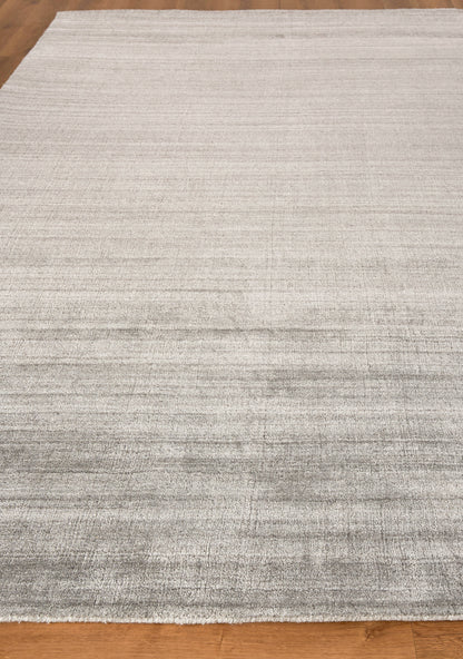 Light gray hand-loomed indoor rug, 2' x 3', with subtle tonal stripes on a hardwood floor; contemporary, versatile living room accessory.