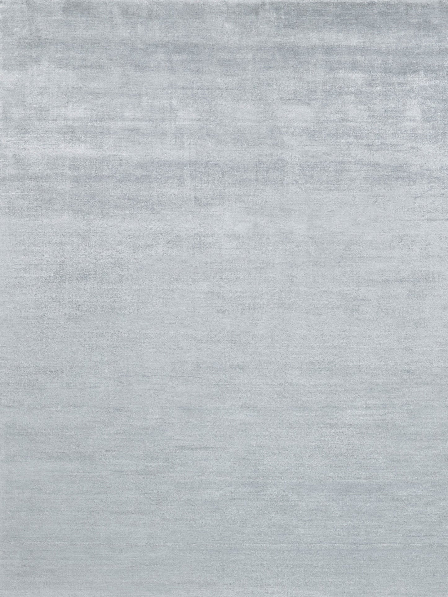 Light gray hand-loomed rug with a subtle textured weave; size 6' x 9'.