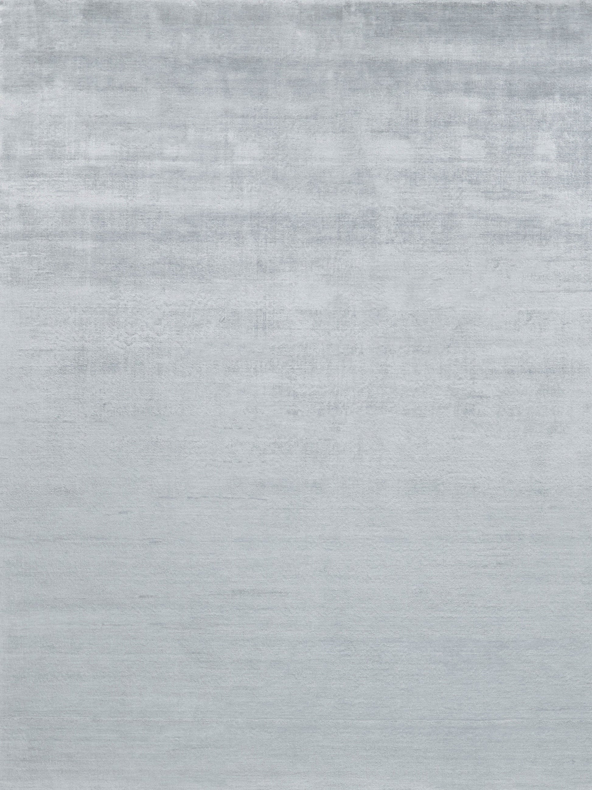Light gray hand-loomed rug with a subtle textured weave; size 6' x 9'.
