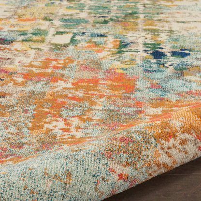 Colorful abstract patterned area rug with teal, orange, pink, and yellow hues; textured pile and folded edge on wood floor