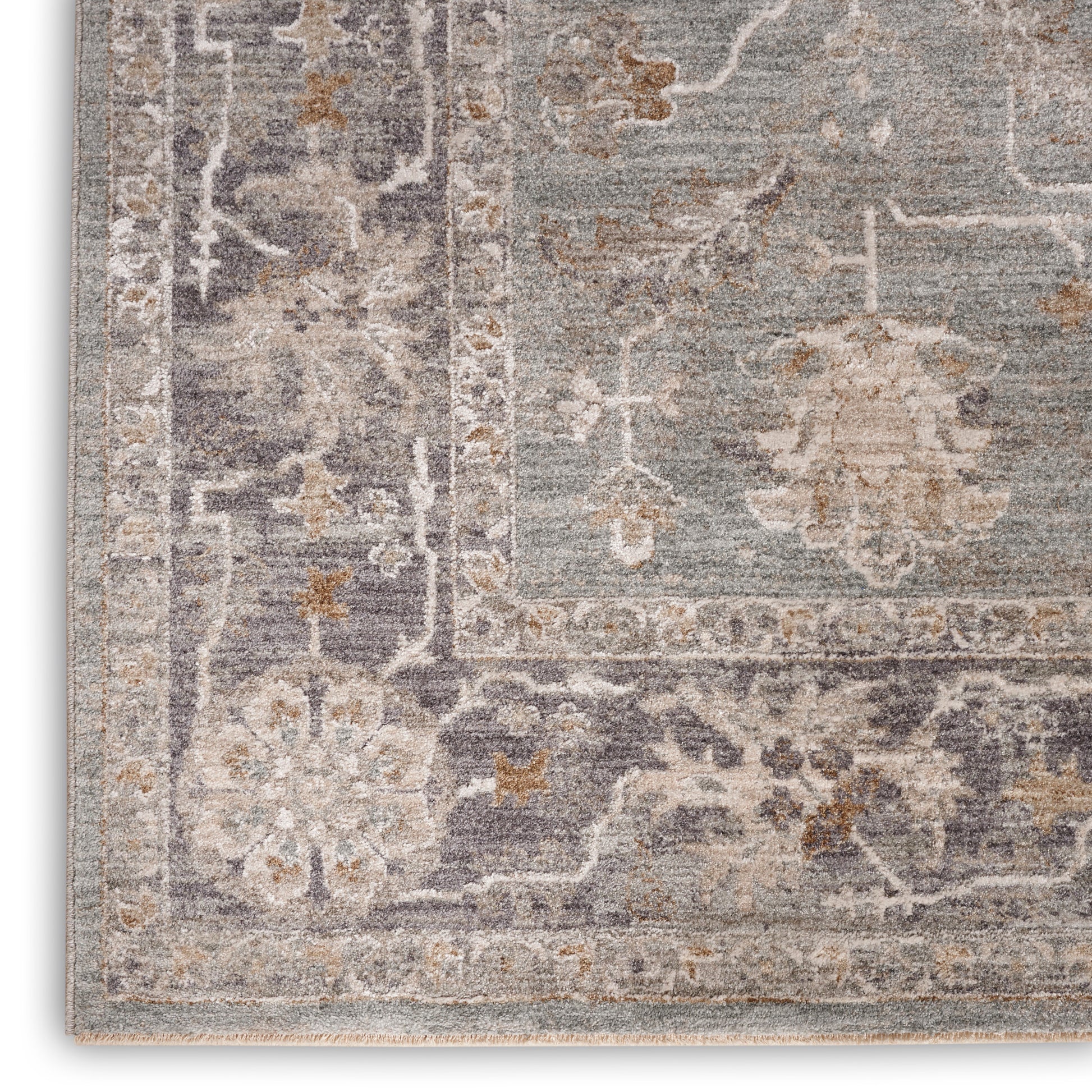 Muted blue-gray oriental rug with beige floral medallions, ornate border and light fringe.