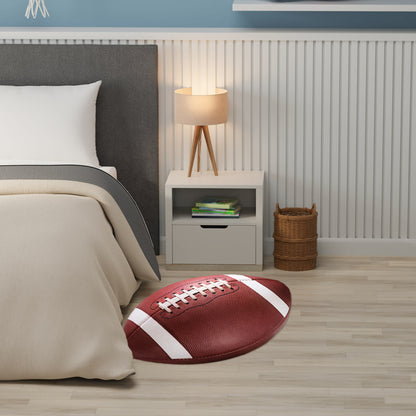 Red football-shaped rug with white laces beside beige bed, gray headboard, white nightstand with lamp, wicker basket.