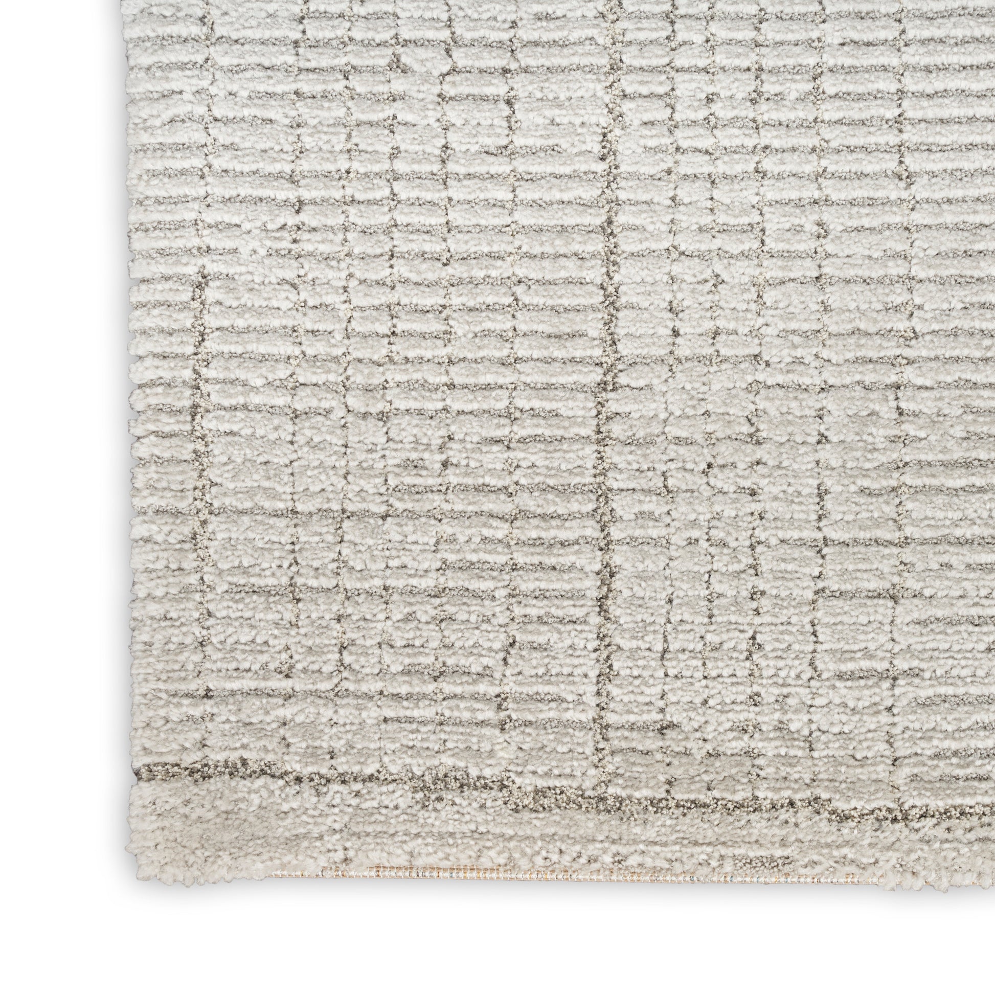 Cream textured area rug with geometric grid pattern & plush pile, light border trim.