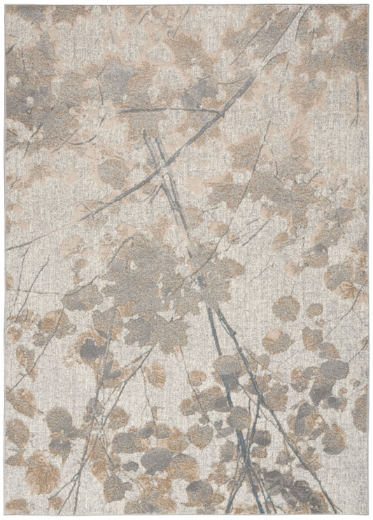 Neutral abstract rug with beige and taupe leaves and grey branches in a soft woven texture.