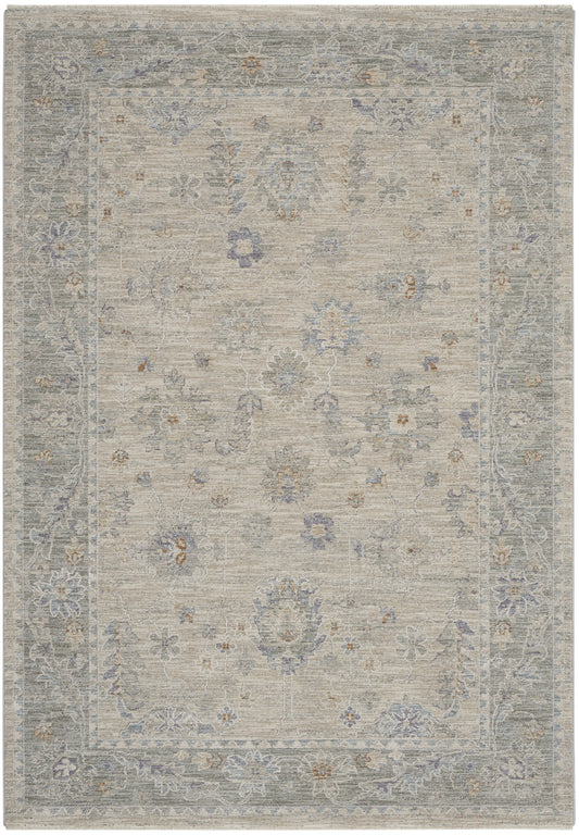 Neutral distressed oriental rug with light beige field, blue-gray floral border and scattered blue and brown blossoms.