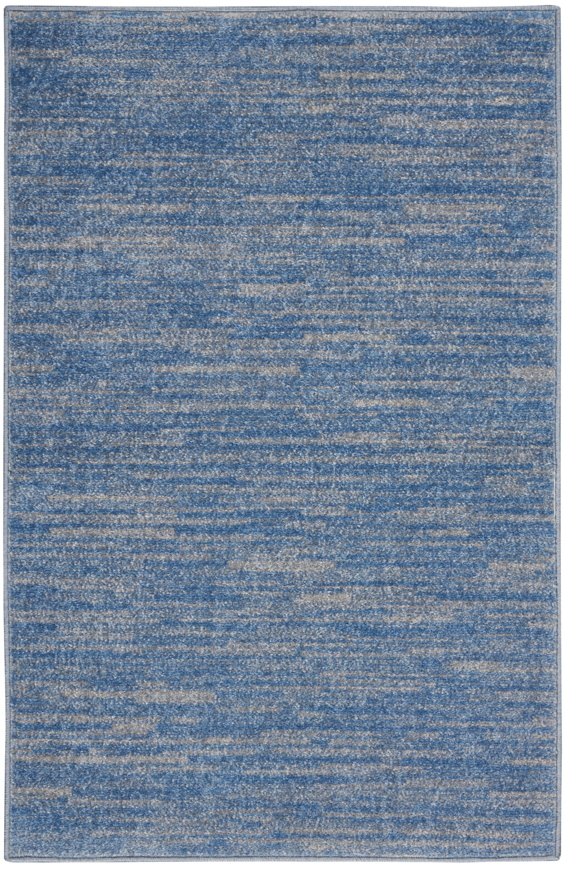 Rectangular blue distressed outdoor rug with beige speckled texture; modern abstract pattern, low-pile.