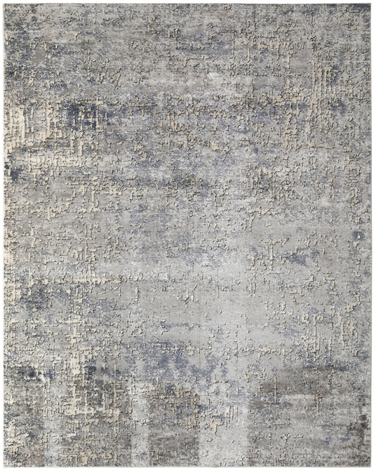Muted gray-blue abstract distressed rug with ivory beige accents; textured, modern living room decor.
