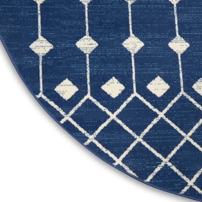 Circular blue rug with white diamond lattice pattern & vertical accents; woven textile.
