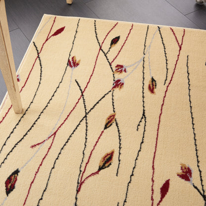 Beige area rug with black & red vertical vine lines & small leaf motifs; wooden table leg visible.