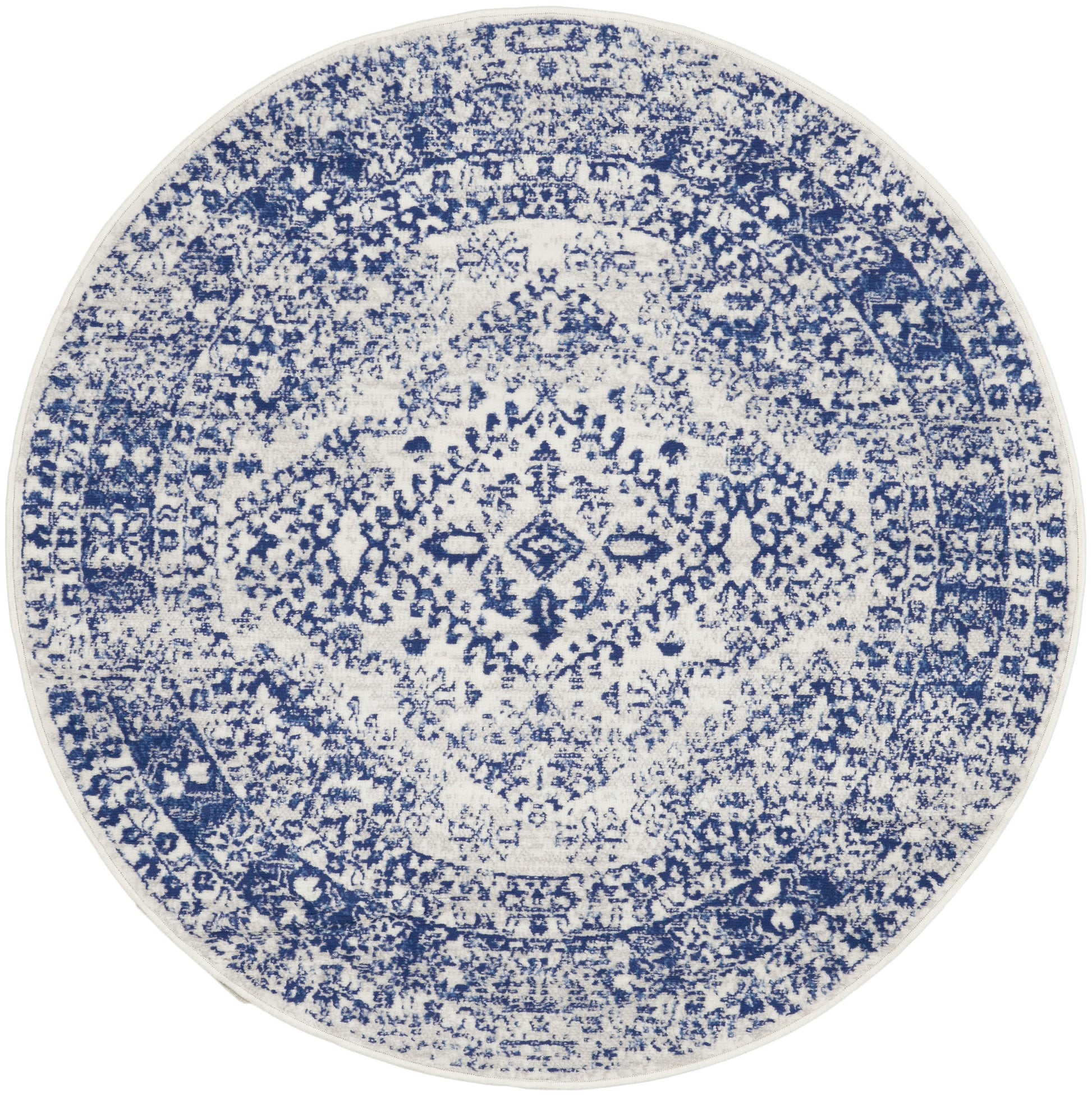 Round blue and white distressed rug with an oriental medallion pattern and intricate detailing.