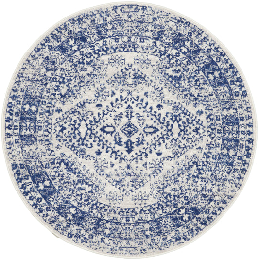 Round blue and white distressed rug with an oriental medallion pattern and intricate detailing.