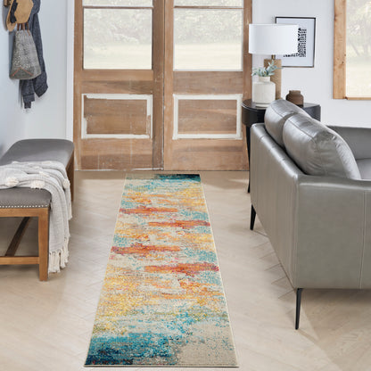 Abstract colorful runner rug with blues, teals, oranges and yellows on light wood floor in a modern living room.