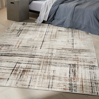 Neutral abstract area rug in beige, cream, black and rust with a geometric linear grid pattern for a modern bedroom.