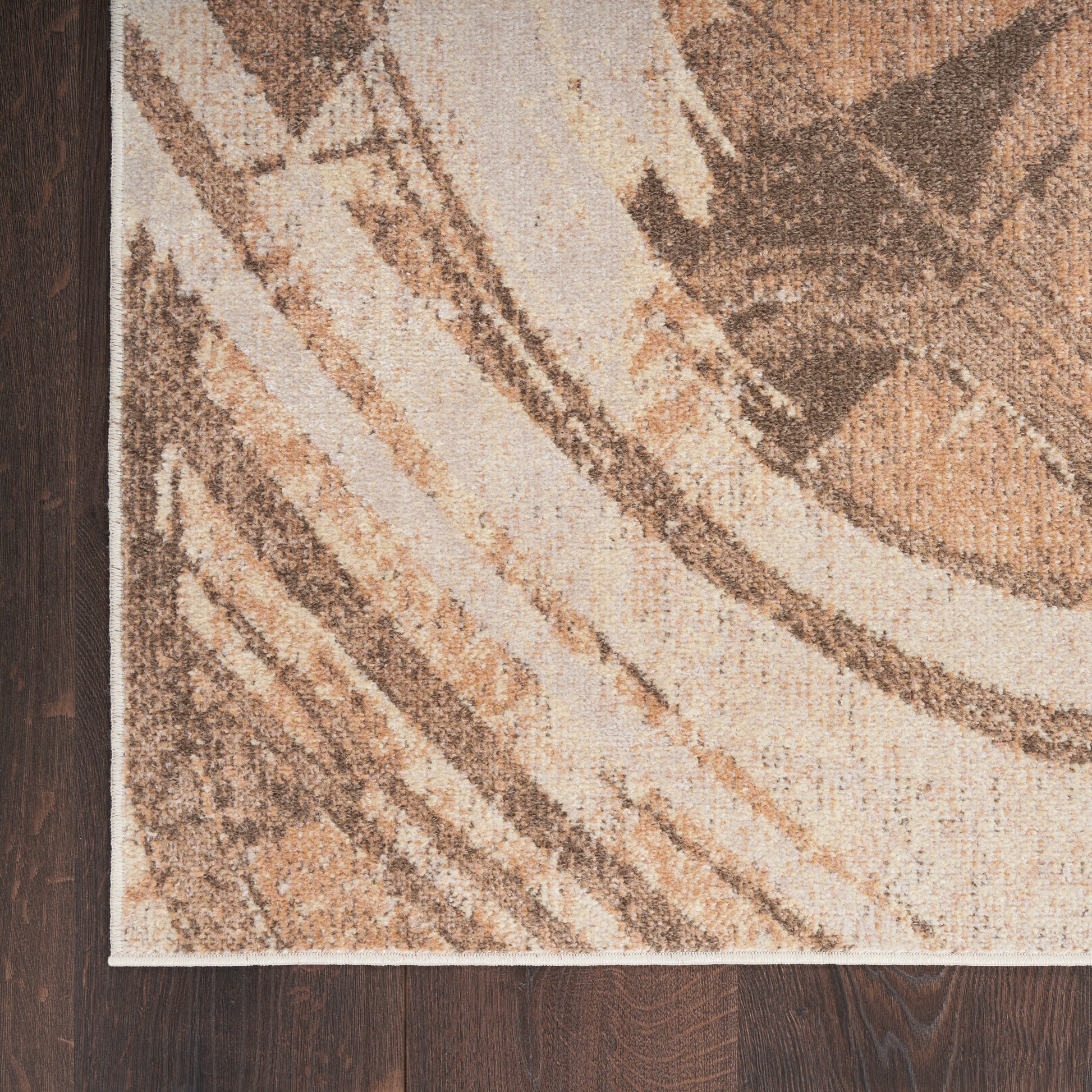 Abstract beige and brown area rug with sweeping curved stripes on dark wood floor.