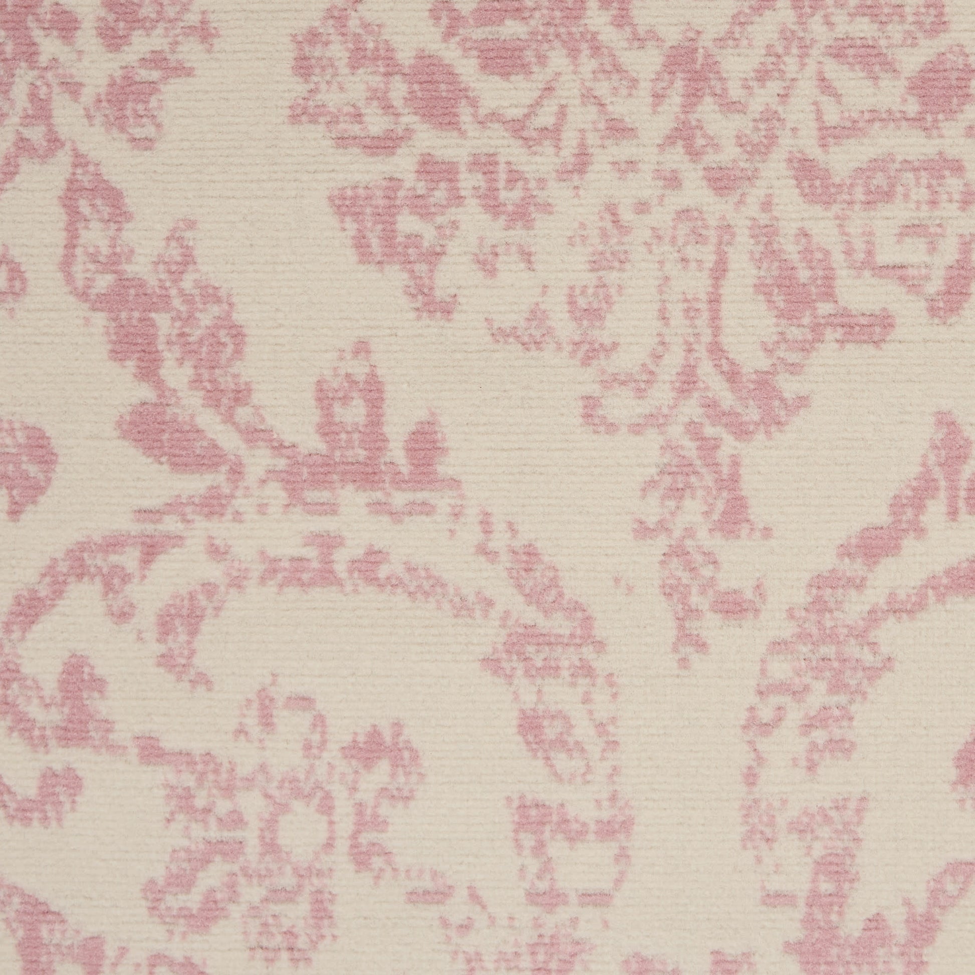 Cream-beige rug with pink damask floral pattern and a subtle woven texture.