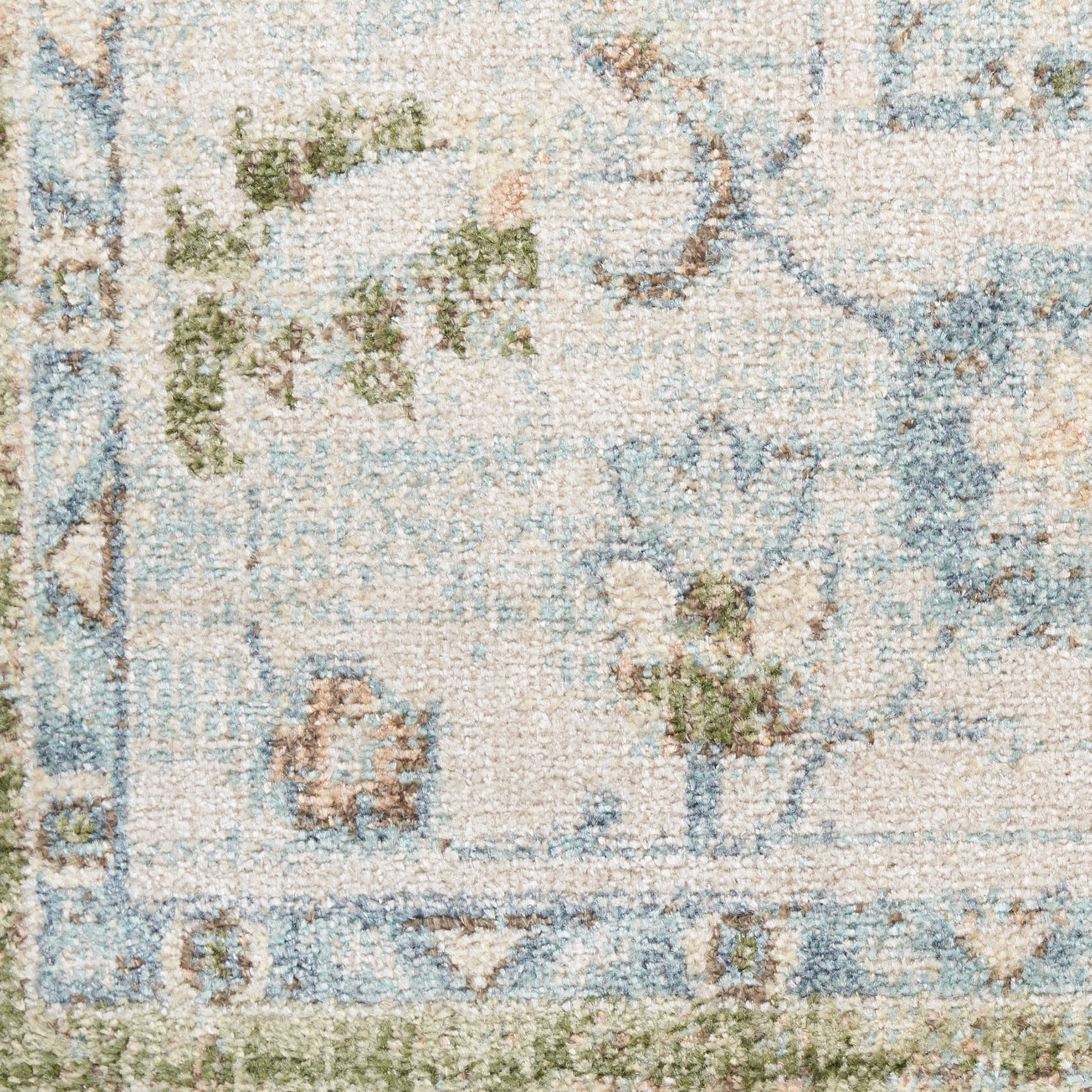 Pastel floral rug with cream base, blue border and green vines; soft tufted texture.