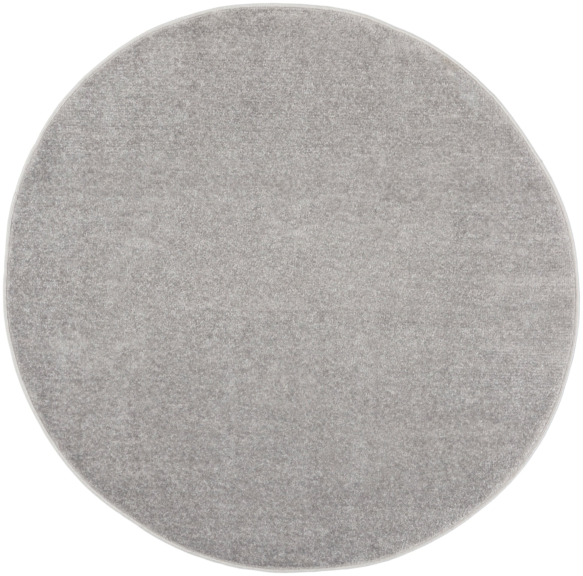 Round light gray outdoor rug with plush pile; 4' diameter, modern minimalist decor.