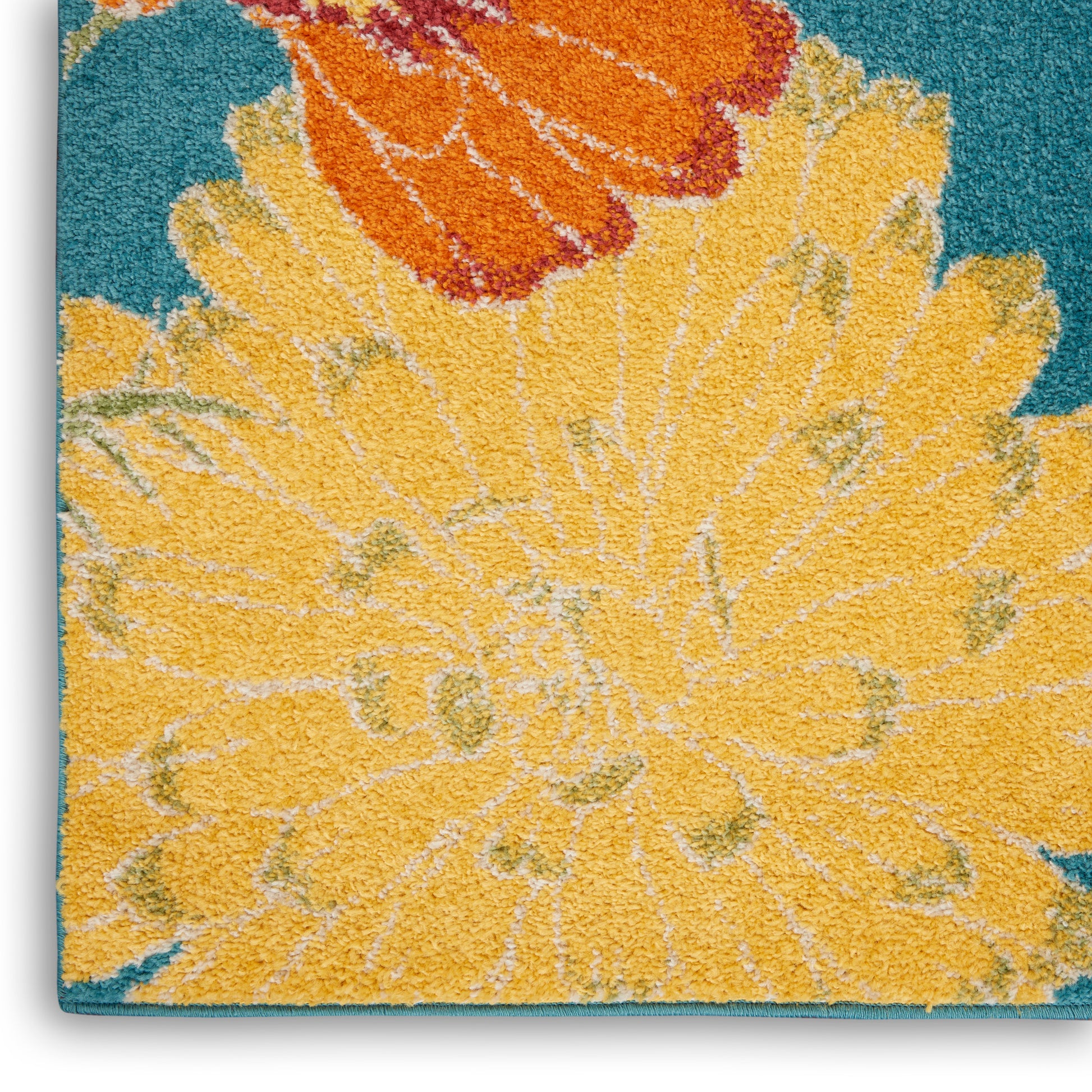 Shaggy rug featuring a large yellow flower with orange accents on a teal background.