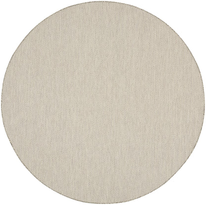 Beige round woven rug.