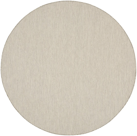 Beige round woven rug.