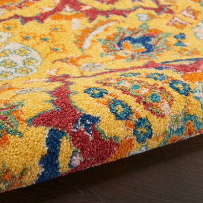 Thick shag rug in bright yellow with red, blue and teal floral patterns; plush decorative floor covering.