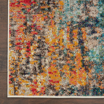 Shaggy, multicolor abstract rug with orange, yellow, blue, teal hues and cream fringe on dark wooden floor.