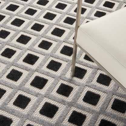 Cream and gray geometric rug with a repeating grid of black square centers.