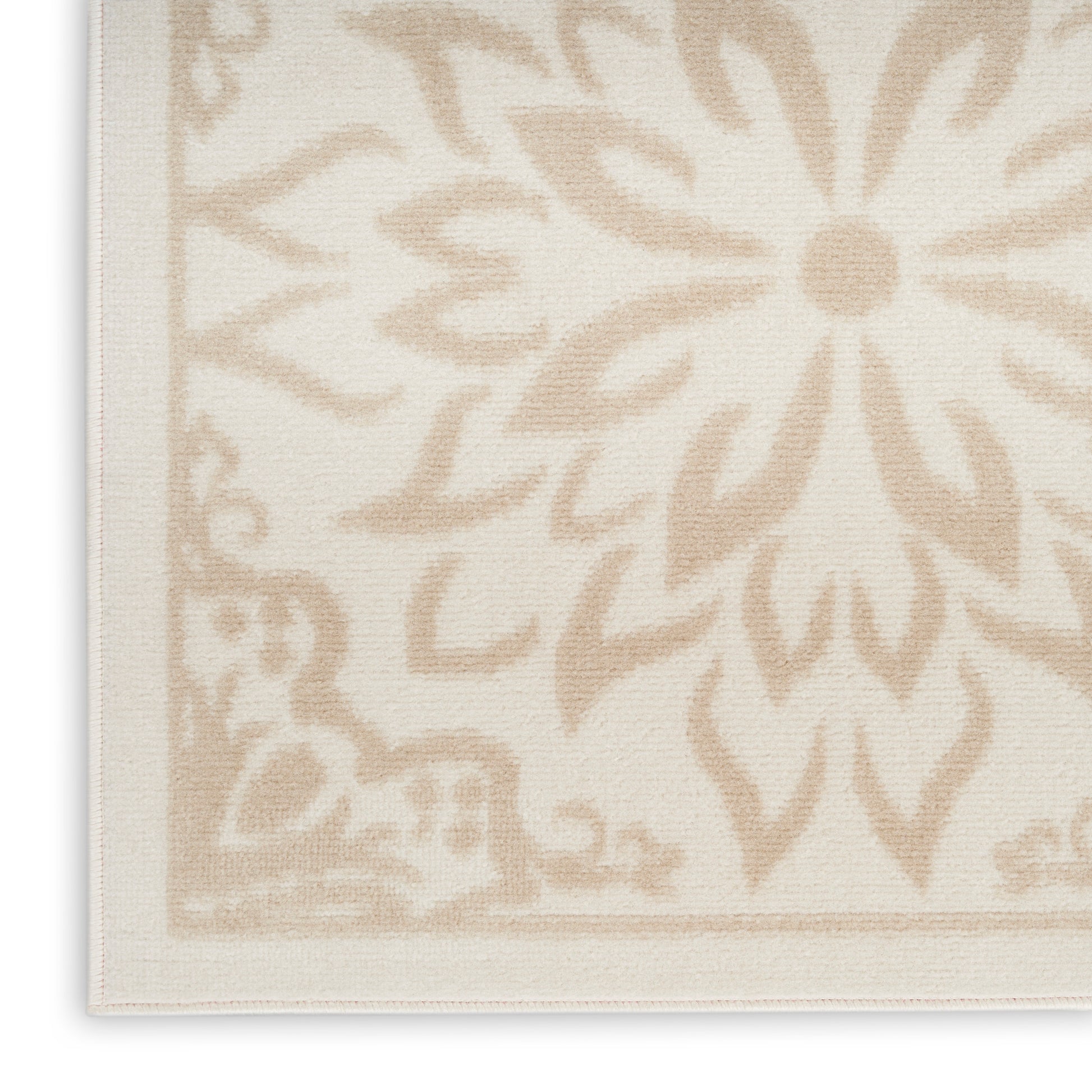 Rectangular beige rug with a large cream floral medallion and bordered edges; woven textured textile.