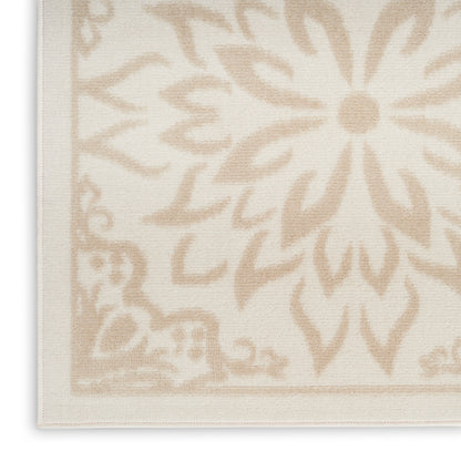 Rectangular beige rug with a large cream floral medallion and bordered edges; woven textured textile.