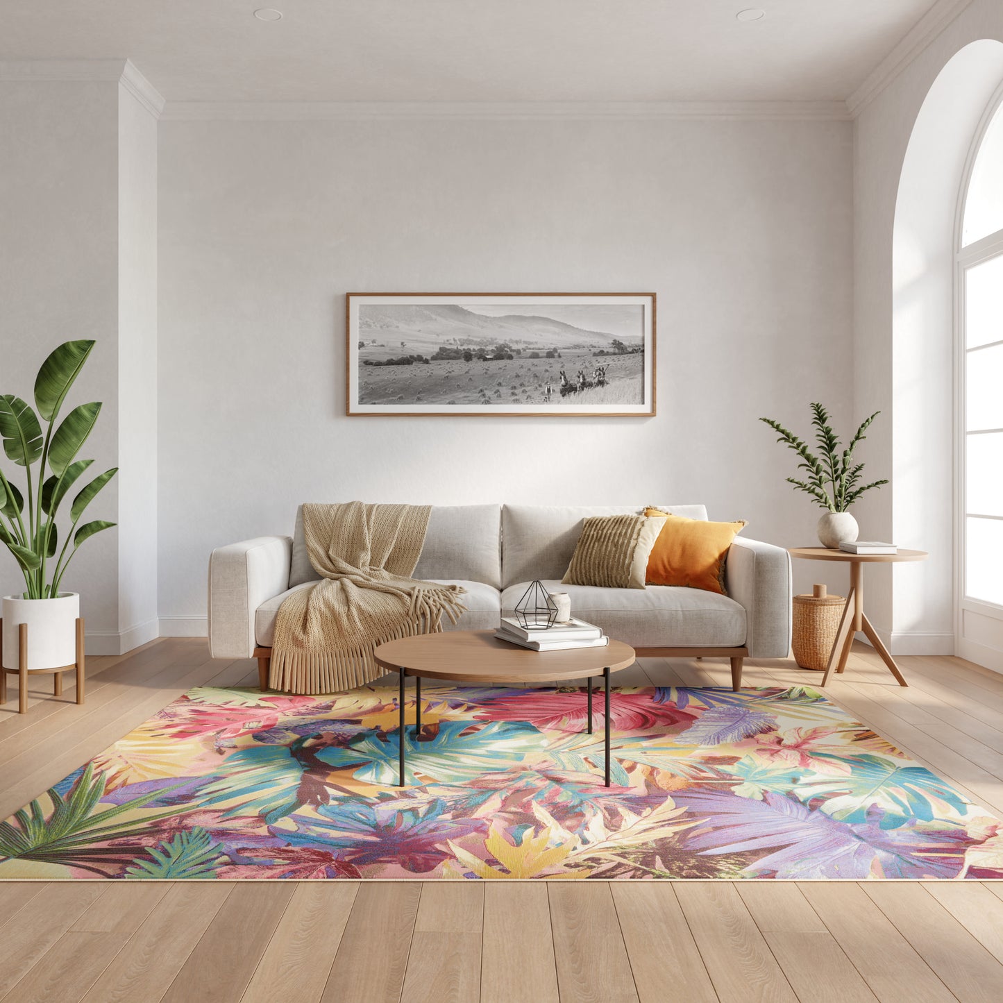 Modern living room with cream sofa, knitted throw, colorful tropical rug, round wood coffee table, and lush plants.