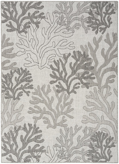 Grey and ivory coral-pattern rug with woven texture and organic branch shapes, coastal-style.