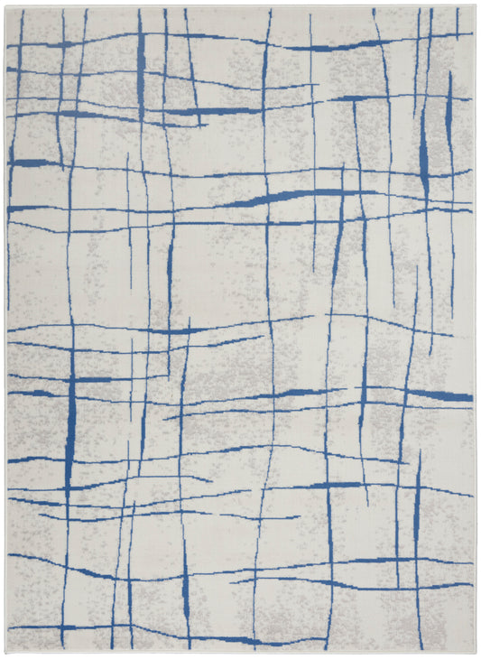 Cream rug with blue intersecting straight lines forming an abstract grid; modern geometric pattern.