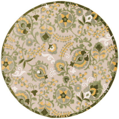 Round decorative rug with green olive and mustard yellow floral damask pattern on beige background.