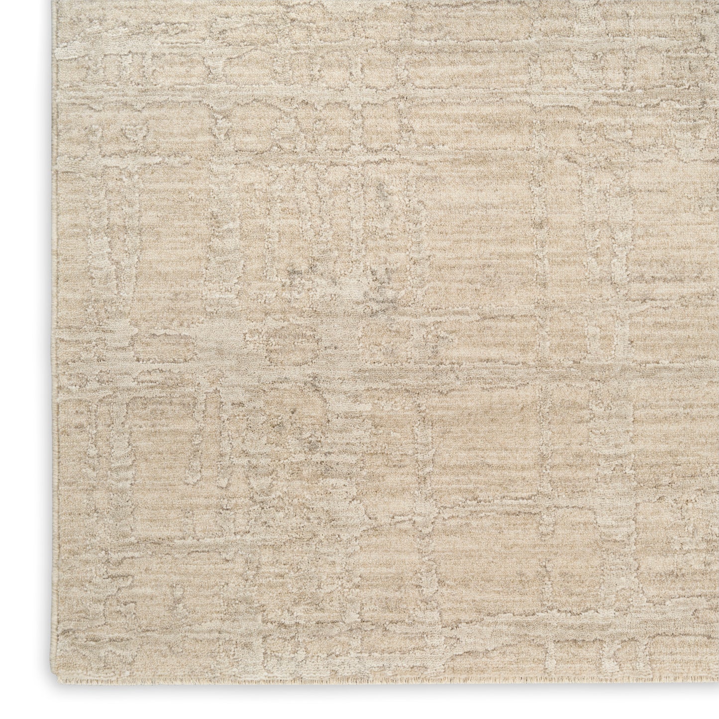 Beige textured area rug with a subtle distressed abstract pattern; plush neutral cream pile.
