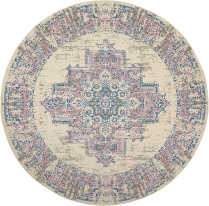 Round distressed beige rug with pink & blue ornate central medallion & decorative border.