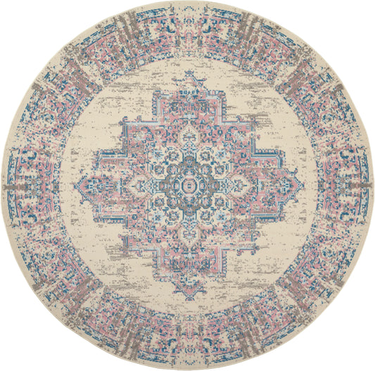 Round distressed beige rug with pink & blue ornate central medallion & decorative border.